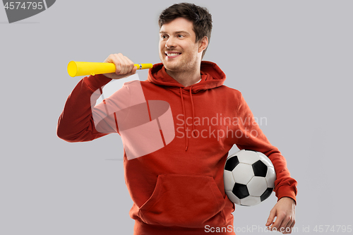 Image of man or football fan with soccer ball and vuvuzela