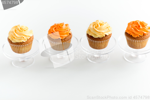 Image of cupcakes with frosting on confectionery stands