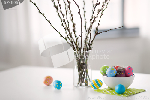 Image of pussy willow branches and colored easter eggs