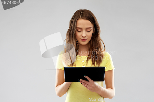 Image of young woman or teenage girl using tablet computer