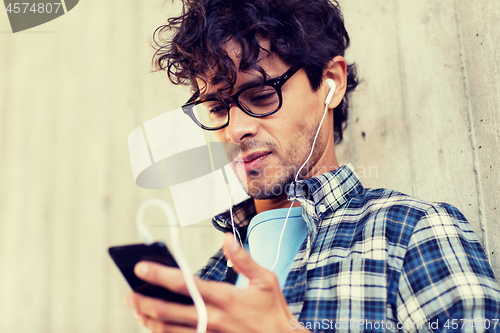 Image of man with earphones and smartphone listening music