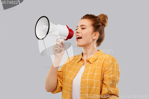 Image of red haired teenage girl speaking to megaphone