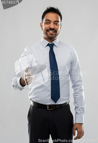 Image of indian businessman stretching hand for handshake