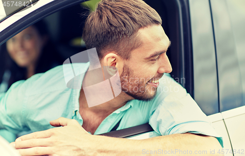 Image of happy smiling man driving in car