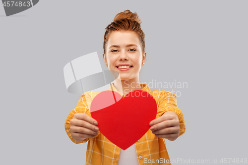 Image of smiling red haired teenage girl with heart