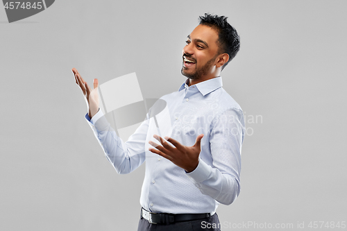 Image of happy indian businessman in shirt over grey