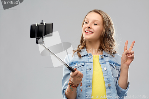 Image of teenage girl taking selfie by smartphone