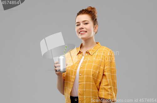 Image of young woman or teenage girl drinking soda from can