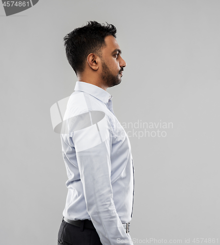 Image of indian businessman side view over grey background