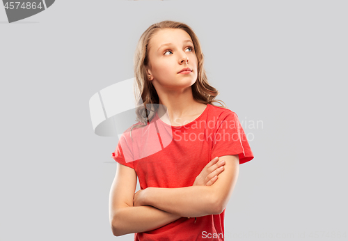 Image of teenage girl in red t-shirt with crossed arms