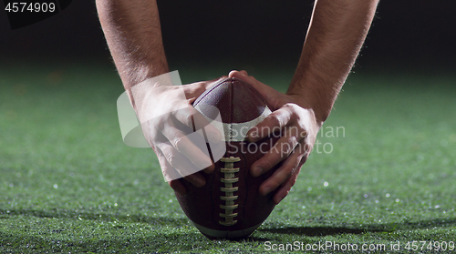 Image of American football player starting football game