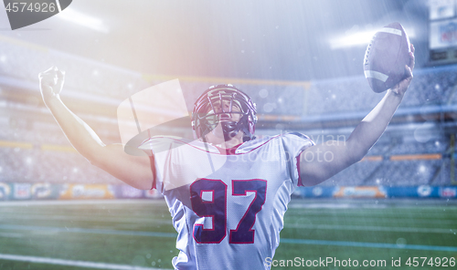 Image of american football player celebrating after scoring a touchdown