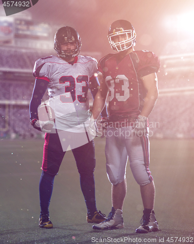 Image of Two American football players standing  on the field