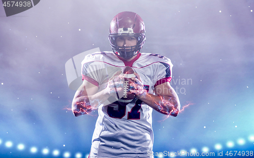 Image of portrait of confident American football player standing on the f