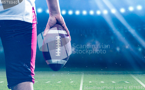 Image of closeup rear view of young confident American football player