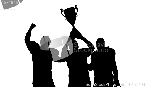 Image of american football team with trophy celebrating victory