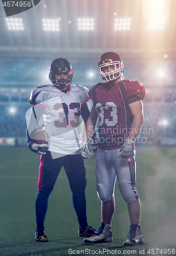 Image of Two American football players standing  on the field