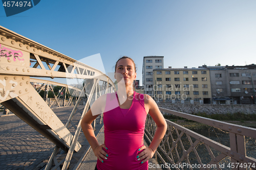 Image of portrait of a jogging woman at sunny morning
