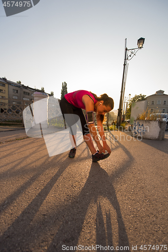 Image of athlete woman warming up and stretching