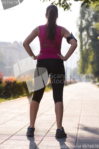 Image of woman jogging at sunny morning