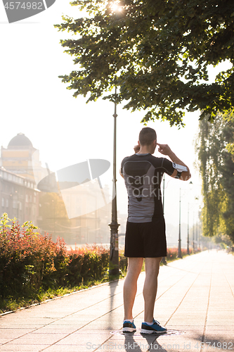 Image of man jogging at sunny morning