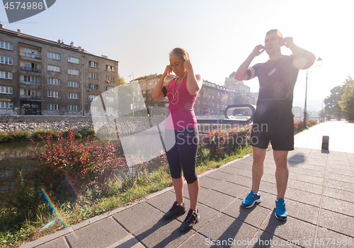 Image of young couple jogging  in the city