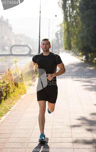 Image of man jogging at sunny morning