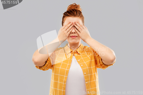 Image of red haired teenage girl in checkered shirt