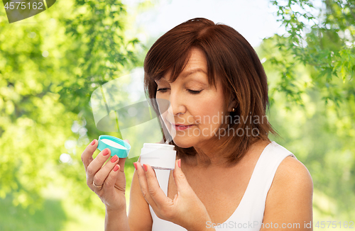 Image of senior woman with cream jar