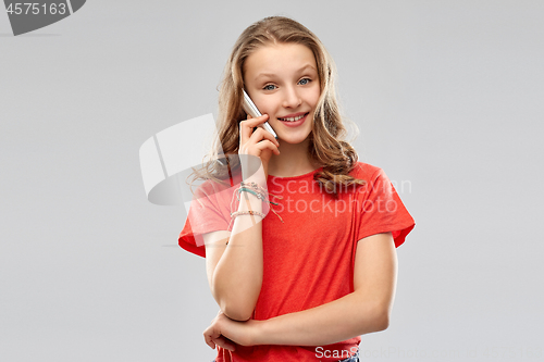 Image of smiling teenage girl calling on smartphone