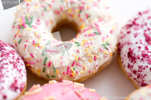 Image of close up of glazed donuts on white table