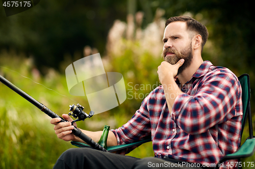 Image of bearded fisherman with fishing rod