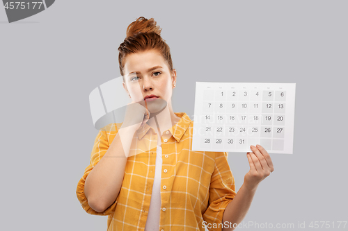 Image of sad red haired teenage girl with calendar sheet