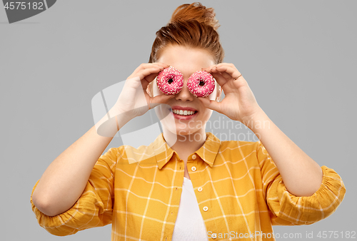 Image of funny teenage girl with donuts instead of eyes