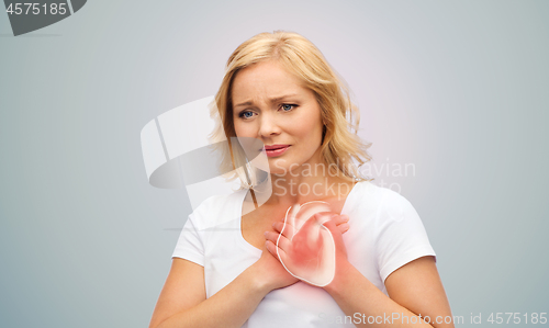 Image of unhappy woman having heart attack or heartache