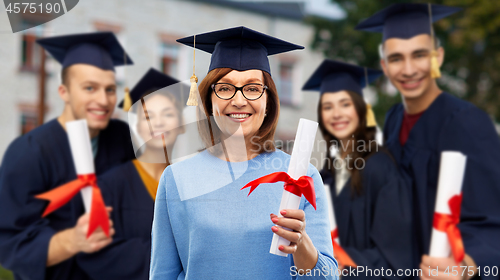 Image of happy senior graduate student woman with diploma