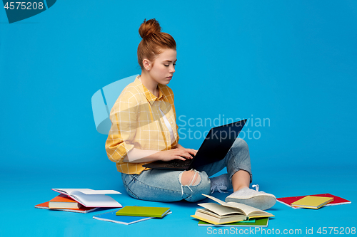 Image of redhead teenage student girl with laptop and books