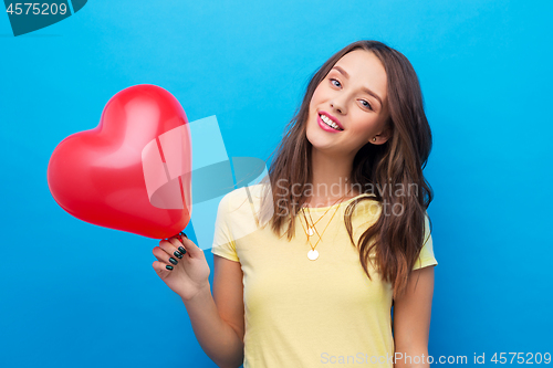 Image of teenage girl with red heart-shaped balloon