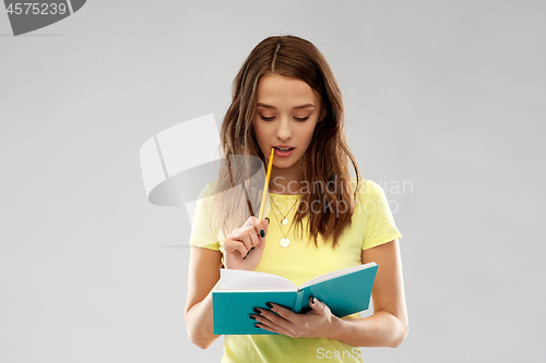 Image of teenage student girl with diary or notebook