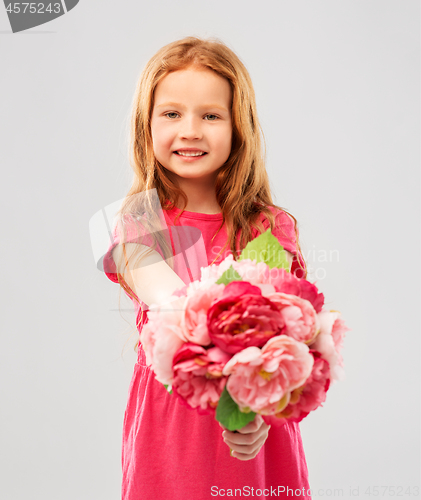 Image of happy red haired girl with flowers