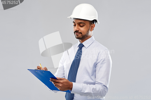 Image of architect or businessman in helmet with clipboard