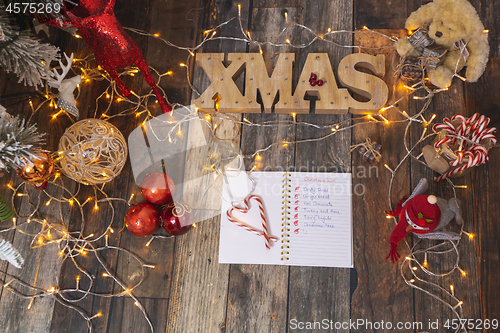 Image of Christmas List on rustic wood with Christmas decorations