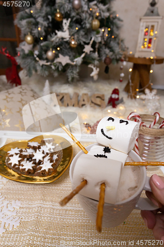 Image of Marshmallow snowman float in hot chocolate at Christmas