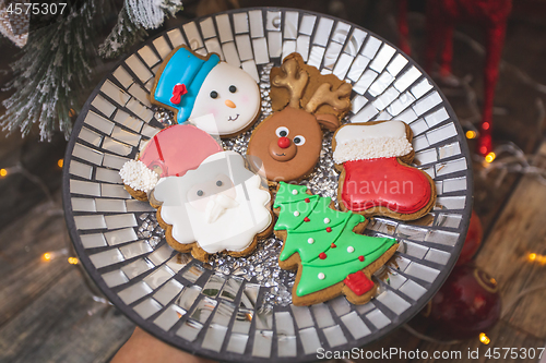 Image of Iced gingerbread cookies by the Christmas tree