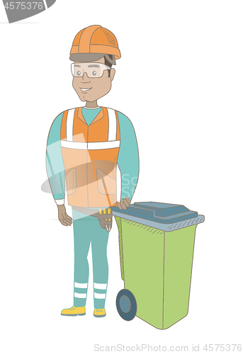 Image of Young hispanic builder pushing recycle bin