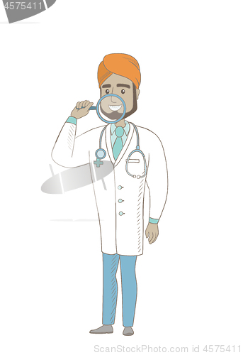 Image of Indian dentist examining teeth with a magnifier