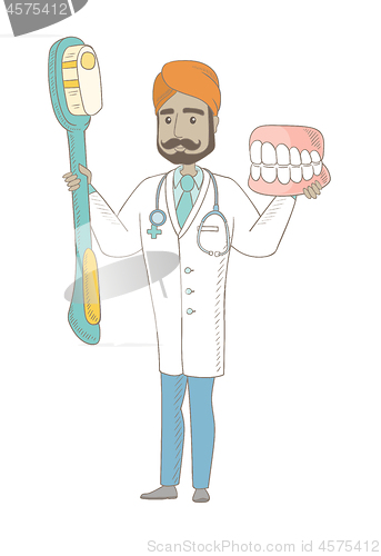 Image of Dentist with dental jaw model and toothbrush.