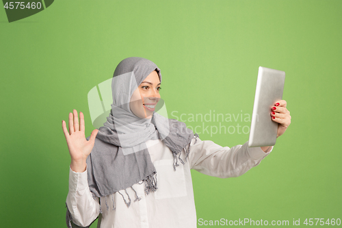 Image of Happy arab woman in hijab. Portrait of smiling girl, posing at studio background