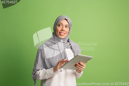 Image of Happy arab woman in hijab. Portrait of smiling girl, posing at studio background