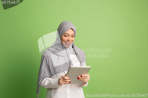 Image of Happy arab woman in hijab. Portrait of smiling girl, posing at studio background